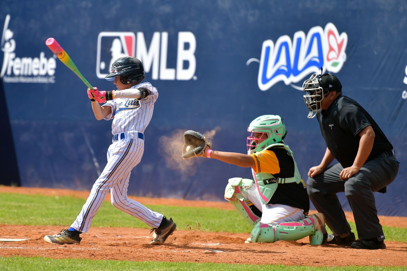 Jugador infantil al bate durante un partido de la MLB Cup México 2026 en el Potosí Béisbol Park de San Luis Potosí.
